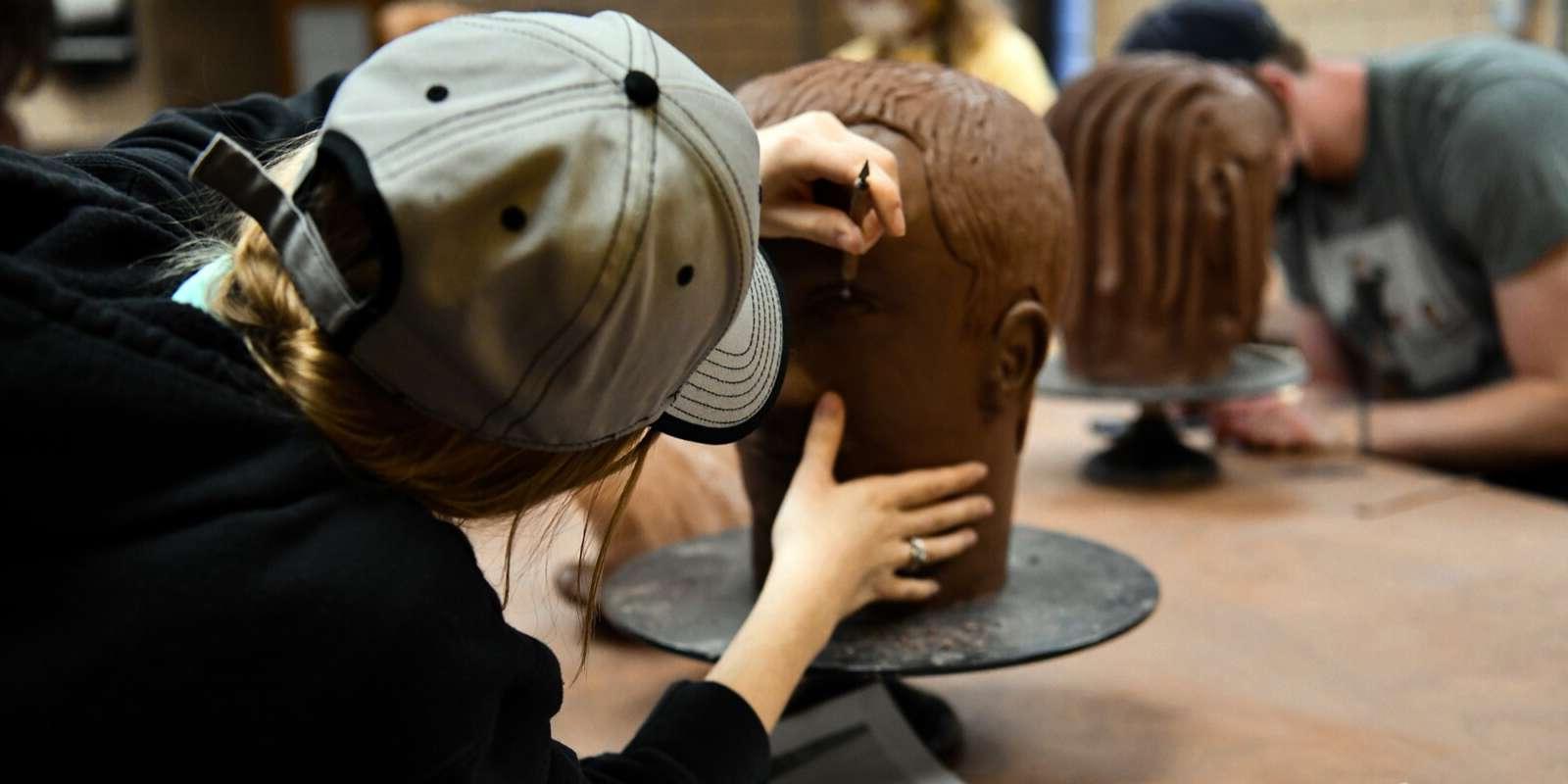 Students sculpting heads